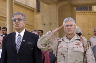 
U.S. Ambassador to Iraq Zalmay Khalilzad, left, and the U.S. commander in Iraq, Gen. George Casey, attend the ceremony marking the handover of a presidential palace in Tikrit, Saddam Hussein's hometown, to Iraqi forces, on Nov. 22, 2005. 
 (File/Associated Press / The Spokesman-Review)