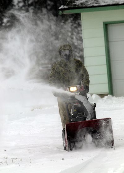 Harvey Brink snowblows his driveway at Highway 53 and Ramsey Rd. in Rathdrum, Idaho during the blizzard on Thursday, Feb. 24, 2011. The Idaho State  Patrol urged motorists to avoid the Rathdrum Prairie due to drifting and blowing snow.  (J. Bart Rayniak / The Spokesman-Review)