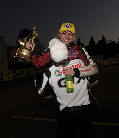 Courtney Force gets a big hug from her father John after winning the NHRA season-opener at Pomona. (Photo courtesy of NHRA)