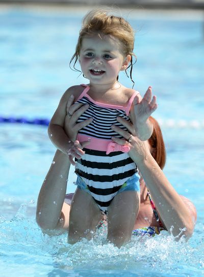 Brooklyn, 18 months old, is dipped into the water by her mother, Carrie Wiltsie, during a water babies class in Twin Falls, Idaho.