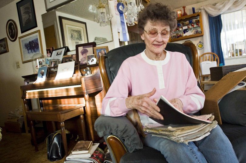 Darlyne Markus flips through past payment books in the living room of her Nampa, Idaho home on Thursday, Feb. 25, 2010. Markus was recognized by the Guinness World Records as the world's longest serving paper girl for her 50 years of service to the Idaho Press-Tribune. (Charlie Litchfield / Idaho Press-tribune)