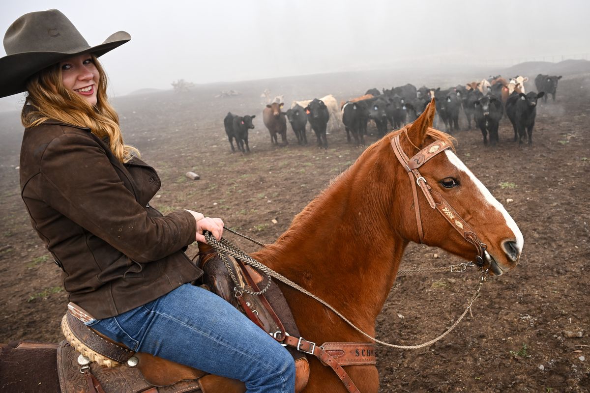 Cattle rancher Annabelle Schmidt stops to smile for a photo as she rides her horse Cleo while checking on cattle Friday in Deer Park.  (Tyler Tjomsland/The Spokesman-Review)