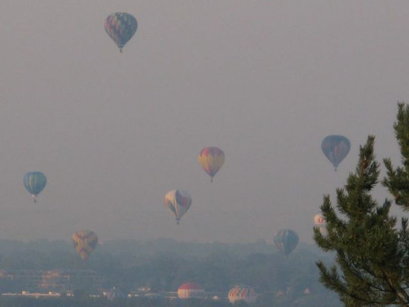 Hot-air balloons rise in smoky skies over Boise on Thursday, in the 2012 Spirit of Boise Balloon Classic. (Betsy Russell)