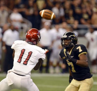 Eastern Washington’s Nicholas Edwards collects pass over Idaho’s Trey Williams. (Associated Press)