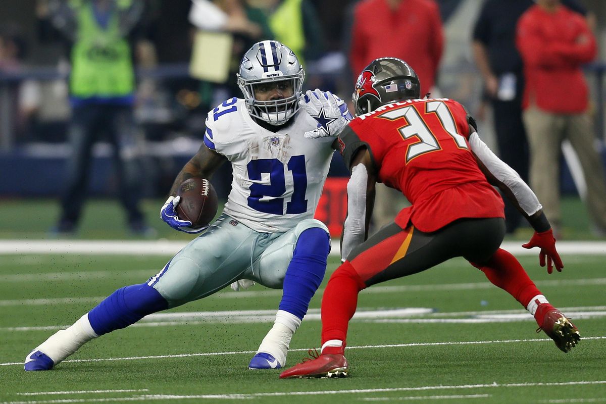 Dallas  running back Ezekiel Elliott  attempts to evade a tackle by Tampa Bay  safety Jordan Whitehead  after Elliott caught a pass in the first half  Dec. 23  in Arlington, Texas.  Elliott won his second NFL rushing title in three seasons for a Dallas offense that has been defined by the ground game for several years. (Roger Steinman / AP)