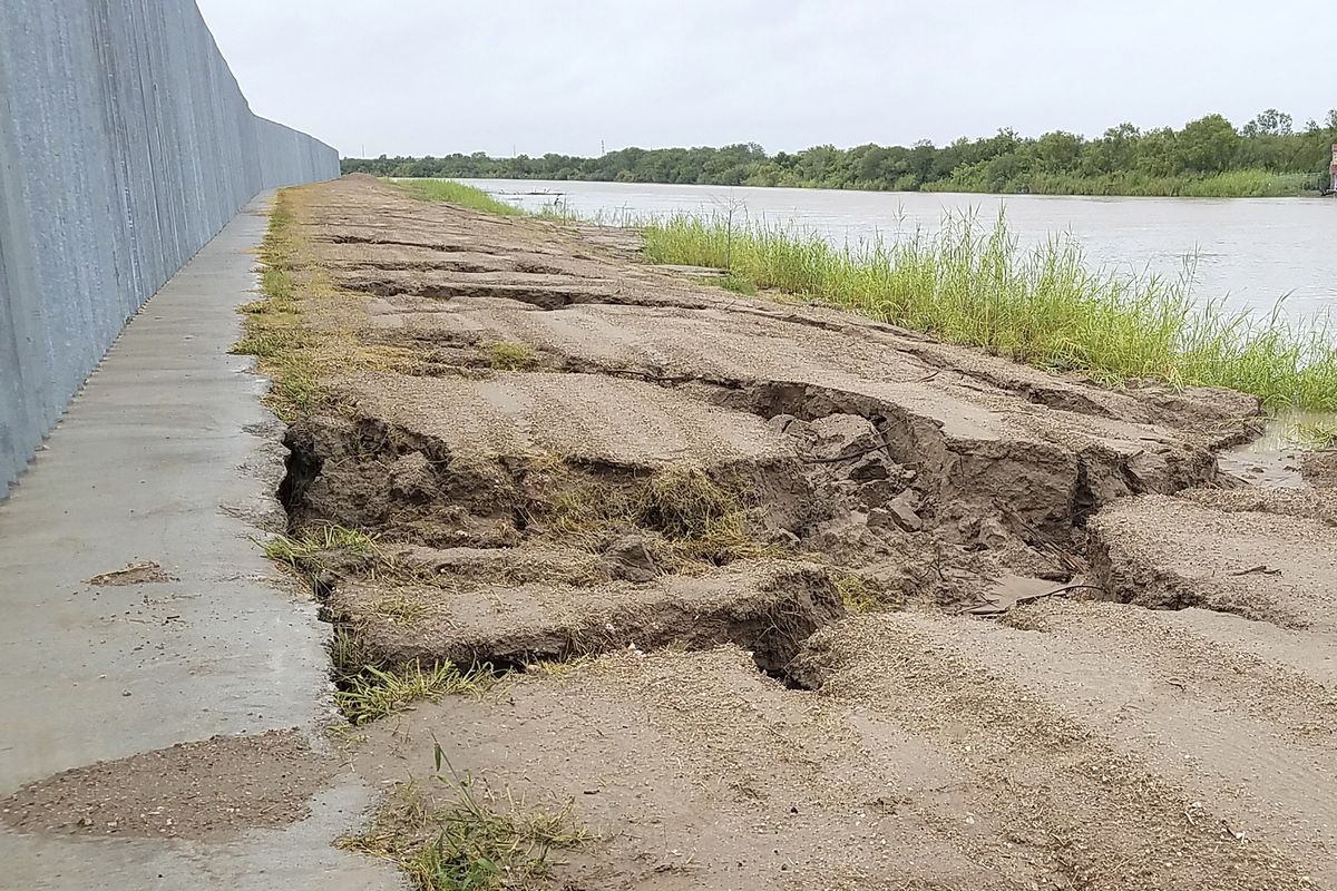 This Sunday, July 26, 2020, photo provided by the National Butterfly Center, shows damage caused by Tropical Storm Hanna at the Fisher border wall, a privately funded border fence on the Rio Grande River near Mission, Texas. The wall was built by a construction company that