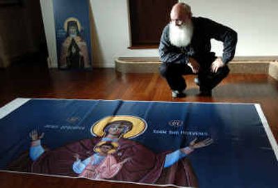 
Church member Niles Graham looks Friday at a print of 