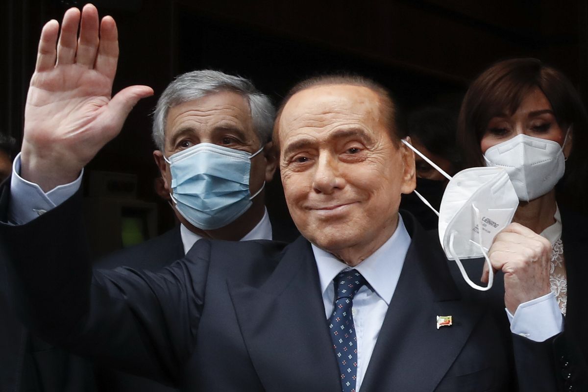 Former Italian Premier Silvio Berlusconi waves to reporters as he arrives at the Chamber of Deputies to meet Mario Draghi, in Rome, on Feb. 9, 2021. Former premier Silvio Berlusconi has bowed out of Italy’s presidential election set for next week. Berlusconi, 85, said in a statement on Saturday that he had decided to “take another step on the path of national responsibility.” The media mogul  insisted he had nailed down enough voters to become head of state, but he asked his supporters not to cast ballots for him.  (Alessandra Tarantino)