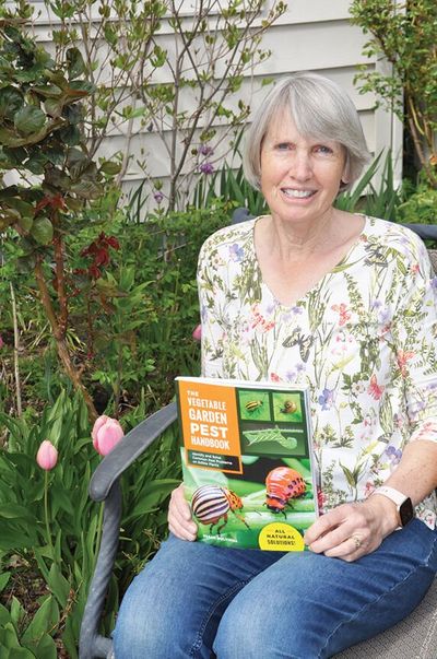 Susan Mulvihill, a Spokesman-Review gardening columnist and an author, shows her new book, The Vegetable Garden Pest Handbook, published this year by Cool Springs Press. Consider putting it under the tree for a gardener in your life this holiday season, Pat Munts writes.  (Pat Munts/For The Spokesman-Review)