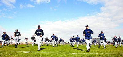 
Seattle players jog Tuesday in Peoria, Ariz. 
 (Associated Press / The Spokesman-Review)