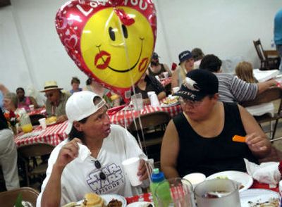 
Dave Chapman, left, chats with his fiancee, Kathy Herman, during the annual picnic at the Women's and Children's Free Restaurant Thursday afternoon. 
 (Holly Pickett / The Spokesman-Review)
