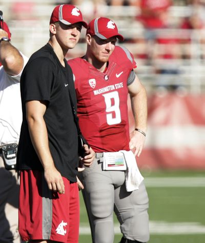 Washington State quarterbacks Jeff Tuel, left, and Marshall Lobbestael (9) watch the videoboard during a time out in the fourth quarter of an NCAA college football game against Idaho State last Saturday in Pullman. (Associated Press)