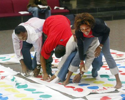 Jacob Jenkins, Ramone Robinson, Nelson Miller and Tairisha Sawyer play Twister in Edwardsville, Illinois, on Sept. 22, 2004. Charles Foley, inventor of Twister, died on July 1, 2013, in St. Louis Park, Minnesota, according to his son, Mark Foley. He was 82. (Wayne Crosslin / AP)