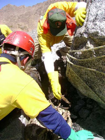 
Members of a National Park Service rescue team carefully remove the parachute to protect evidence. Photo courtesy National Park Service
 (Photo courtesy National Park Service / The Spokesman-Review)