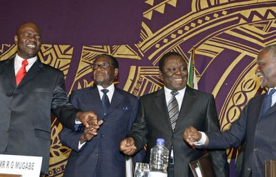 President Robert Mugabe, center left, stands with MDC minority faction leader Arthur Mutambara, left, South African President Thabo Mbeki and Morgan Tsvangirai, Zimbabwe prime minster.  (Associated Press / The Spokesman-Review)