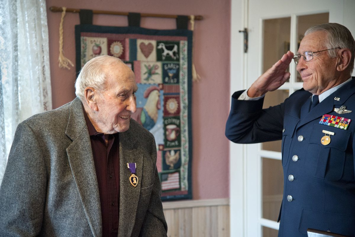 Col. Chuck Lehman USAF (Ret.), right, salutes Lloyd Phillips after Lehman presented Phillips the Purple Heart for his service during World War II in Urbach, Germany, in 1945. The ceremony was April 4 at Phillips’ Spokane Valley home. (Dan Pelle)