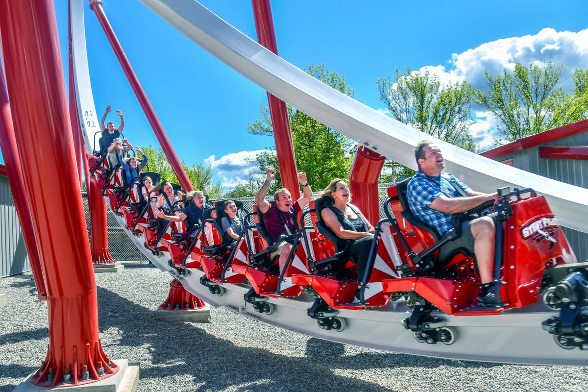 The first official riders of Silverwood’s new Stunt Pilot roller coaster, from right, Kris Mills. Susan Zappia and Adam Regan, lead the way Saturday as the 106-foot-tall ride roars around the track.  (DAN PELLE/THE SPOKESMAN-REVIEW)
