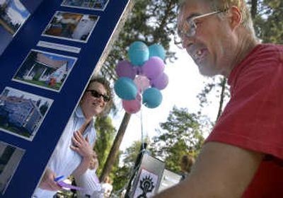 
Terry Coder, right, gets a laugh out of Kimberly Rasp  of Spokane Housing Ventures while they discuss housing possibilities for him Thursday at a homeless services fair in Coeur d