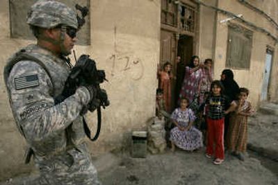 
A U.S. soldier from the 4th Infantry Division, 42nd Field Artillery, patrols a neighborhood in Baghdad in May. U.S. and Iraqi officials are claiming gains against insurgents in the country.  Associated Press
 (Associated Press / The Spokesman-Review)