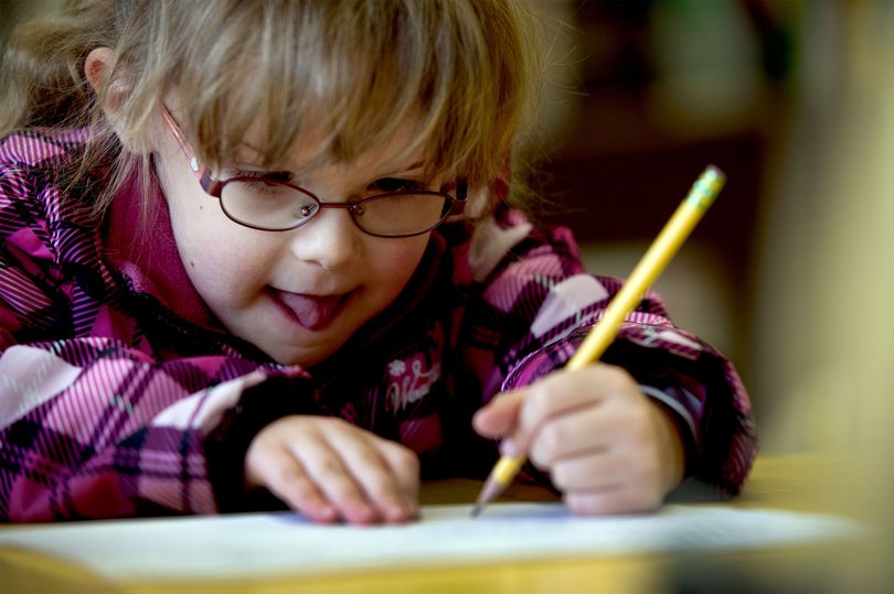 Eden, 6, writes her name during kindergarten registration in 2014. (Kathy Plonka / The Spokesman-Review)