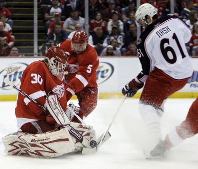 Detroit goalie Chris Osgood stops shot by Columbus’ Rick Nash.   (Associated Press / The Spokesman-Review)