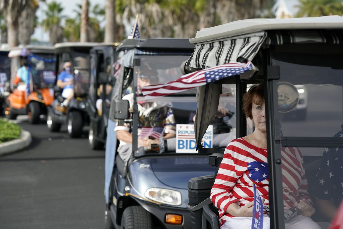 Carts line up before a parade of more than 300 golf carts supporting Democratic presidential candidate former Vice President Joe Biden drove to the Sumter County Elections office drop off their ballots on in The Villages, Fla.  (John Raoux)
