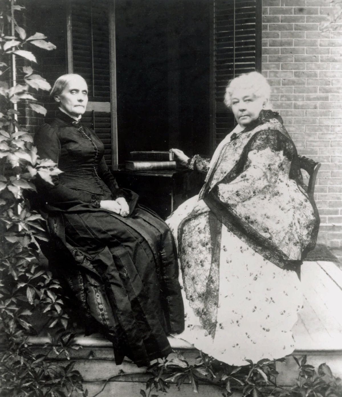 Susan B. Anthony, left, and Elizabeth Cady Stanton sit on the porch of the Anthony house in Rochester, N.Y., in this undated file photo.  (AP Photo/Susan B. Anthony House)