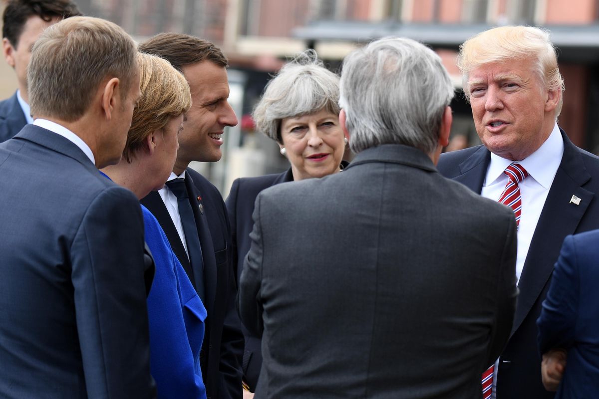 U.S. President Donald Trump, right, speaks to other G-7 leaders including British Prime Minister Theresa May, center, and French President Emmanuel Macron, third from left, in Taormina, Italy, Friday, May 26, 2017. Leaders of the G-7 meet Friday and Saturday, including newcomers  Macron  May, in an effort to forge a new dynamic after a year of global political turmoil amid a rise in nationalism. (Salvatore Cavalli / Associated Press)