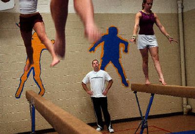 
Gymnastics coach Todd McLean watches his team practice. He and the Eagles are aiming for a 3A/2A state berth this year. 
 (Brian Plonka / The Spokesman-Review)