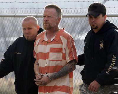 Sanpete sheriff’s officers escort Troy James Knapp, 45, to the Sanpete County Jail on Tuesday in Manti, Utah. (Associated Press)
