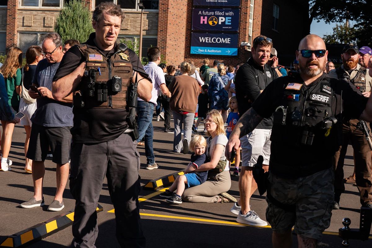 Police work to contain the scene during an active shooter situation on Wednesday at the Annunciation Church in Minneapolis. (Richard Tsong-Taatarii/Minnesota Star Tribune/TNS)