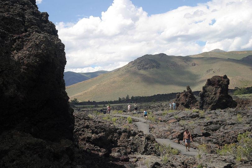 In this July 2012 file photo, people hike the North Crater Flow Trail at Craters of the Moon National Monument, Idaho. (Tetona Dunlap / Times-News via AP)