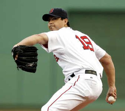 
Boston Red Sox pitcher Josh Beckett delivers a pitch against the Texas Rangers during the first inning of a baseball game at Fenway Park in Boston on June 30.
 (AP / The Spokesman-Review)