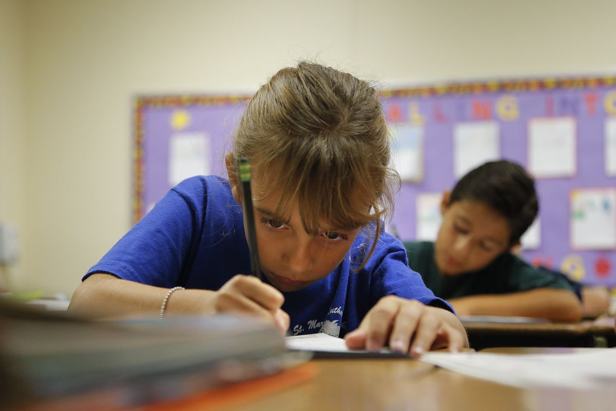 Alexia Herrera practices writing in cursive at St. Mark�s Lutheran School in Hacienda Heights, Calif., Thursday, Oct. 18, 2012. Bucking a growing trend of eliminating cursive from elementary school curriculums or making it optional, California is among the states keeping longhand as a third-grade staple. (Jae Hong / Associated Press)