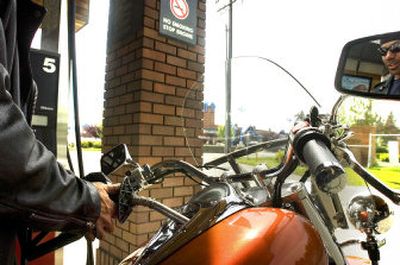 
Jay Daniels fills his motorcycle at the Zip Trip at  57th Avenue and Regal Street on Wednesday, when the average price of gas topped  $3. 