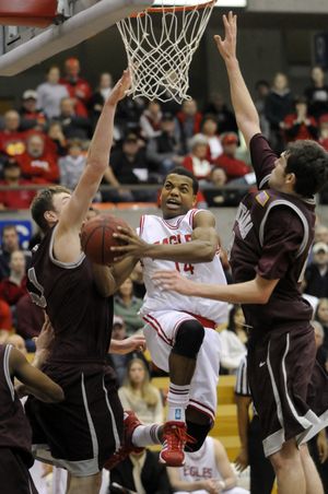 Eastern Washington’s Gary Gibson maneuvers for a second-half basket against Montana’s Brian Qvale, left, and Jack McGillis.  (Jesse Tinsley / The Spokesman-Review)