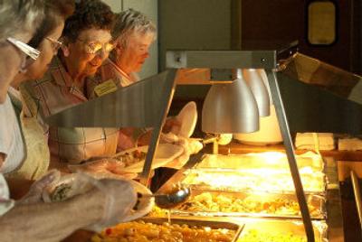 
Naoma Dietz smiles as she helps serve up lunch for seniors at CenterPlace at Mirabeau Point in Spokane Valley on Tuesday. 
 (Liz Kishimoto / The Spokesman-Review)