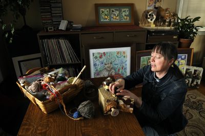 “I like to create as I go,” said artist Lynnette Lawrence, 54, as she works on a found-object sculpture in her South Hill home March 17. Lawrence, an elementary school teacher, also does whimsical drawings of cats.  (Colin Mulvany / The Spokesman-Review)