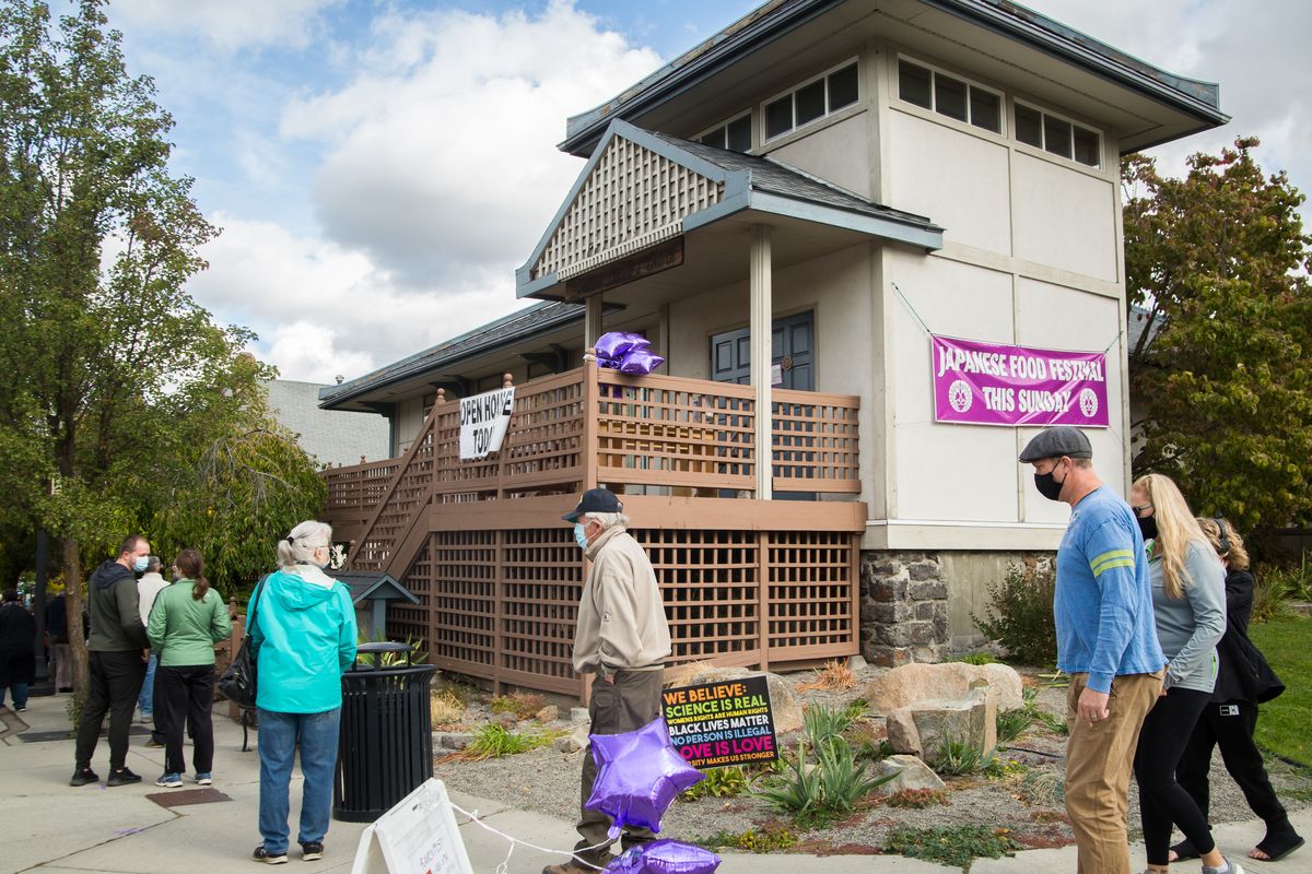 A line of patrons wraps around the building for the 31st annual Ramen Fest, hosted by the Spokane Buddhist Temple in Spokane’s Perry District on Oct. 11, 2020. Though compliance with social distancing guidelines meant this year’s Ramen Fest had to be exclusively take-out, there were no shortage of customers during the authentic Japanese food. The temple has been unable to hold regular services during the COVID-19 pandemic, which has led to a shortage of donations, so proceeds from the Japanese Fall Food Festival will be used to fix its leaking roof. (Libby Kamrowski/ THE SPOKESMAN-REVIEW)
