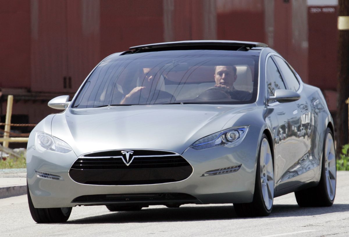 Tesla Motors Chairman and CEO  Elon Musk, at the wheel,  and chief designer Franz von Holzhausen take the prototype Tesla Model S all-electric sedan for a spin after its unveiling in Hawthorne, Calif., on Thursday. Associated Press photos (Associated Press photos / The Spokesman-Review)