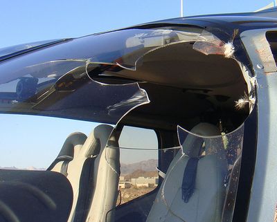 ORG XMIT: LA109  This undated photo released by the National Park Service shows a tour helicopter damaged after striking a bird while returning from the Grand Canyon and making an emergency landing in the Lake Mead National Recreation Area, in Arizona. The pilot, 25-year-old David Supe, of Henderson, was taken to a hospital for treatment of minor cuts. Six passengers on the helicopter weren't injured. (AP Photo/National Park Service) (The Spokesman-Review)