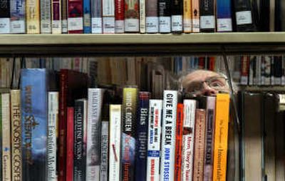 
Jim Livingston of Rathdrum searches through the book shelves at the Rathdrum library. 
 (Kathy Plonka / The Spokesman-Review)