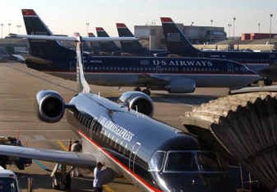 
A US Airways plane pulls into the gate at Pittsburgh International Airport this week. The airline industry appears to have reached a breaking point, with fuel prices unrelentingly high, cash reserves dwindling and customers addicted to cheap fares. 
 (Associated Press / The Spokesman-Review)