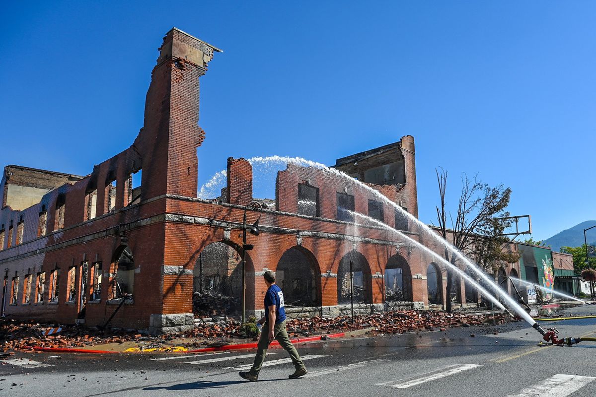 The smoking remains of Sety’s Ace Hardware is doused with water Aug. 18, 2023, in Chewelah.  (SPOKESMAN-REVIEW PHOTO ARCHIVES)