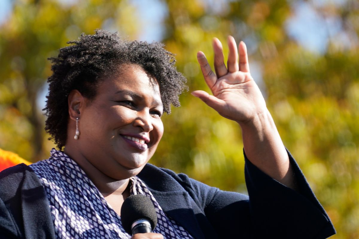 In this Monday, Nov. 2, 2020 photo, Stacey Abrams speaks to Biden supporters as they wait for former President Barack Obama to arrive and speak at a campaign rally for Biden at Turner Field in Atlanta.  (Brynn Anderson)