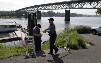 Portland police tape off a dock near Portland’s Sellwood Bridge on Saturday. Portland homicide detectives launched an investigation after a 4-year-old boy and 7-year-old girl were found in the Willamette River. The boy had drowned. The children’s mother was arrested. (Associated Press / The Spokesman-Review)