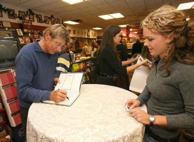 
Joe Namath signs a copy of his self-titled new autobiography for a young fan on the campus of the University of Alabama.
 (Associated Press / The Spokesman-Review)