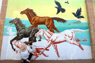 
Robert McNeill, a tattoo artist by trade, works on a large mural on the side of the Mosgrove Gallery in downtown Coeur d'Alene. 
 (Jesse Tinsley / The Spokesman-Review)