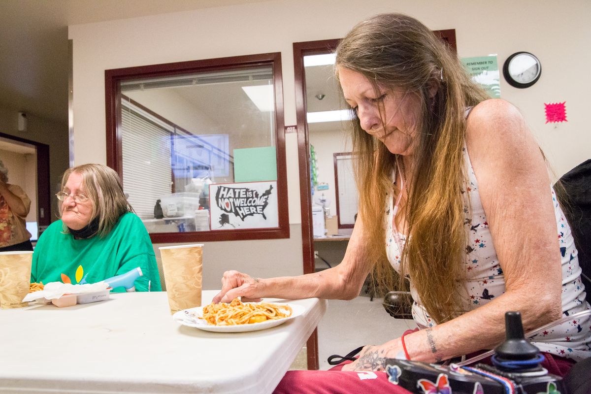 Lea Pearson, left, and Julie Mowery eat plates of spaghetti for dinner at a branch of Hope House on W. 8th Avenue in Spokane on July 14, 2020. Central Food owner David Blaine donated the restaurant