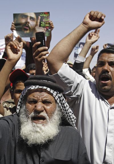Followers of radical Shiite cleric Muqtada al-Sadr hold an anti-U.S. demonstration  Friday in Basra, Iraq.  (Associated Press / The Spokesman-Review)